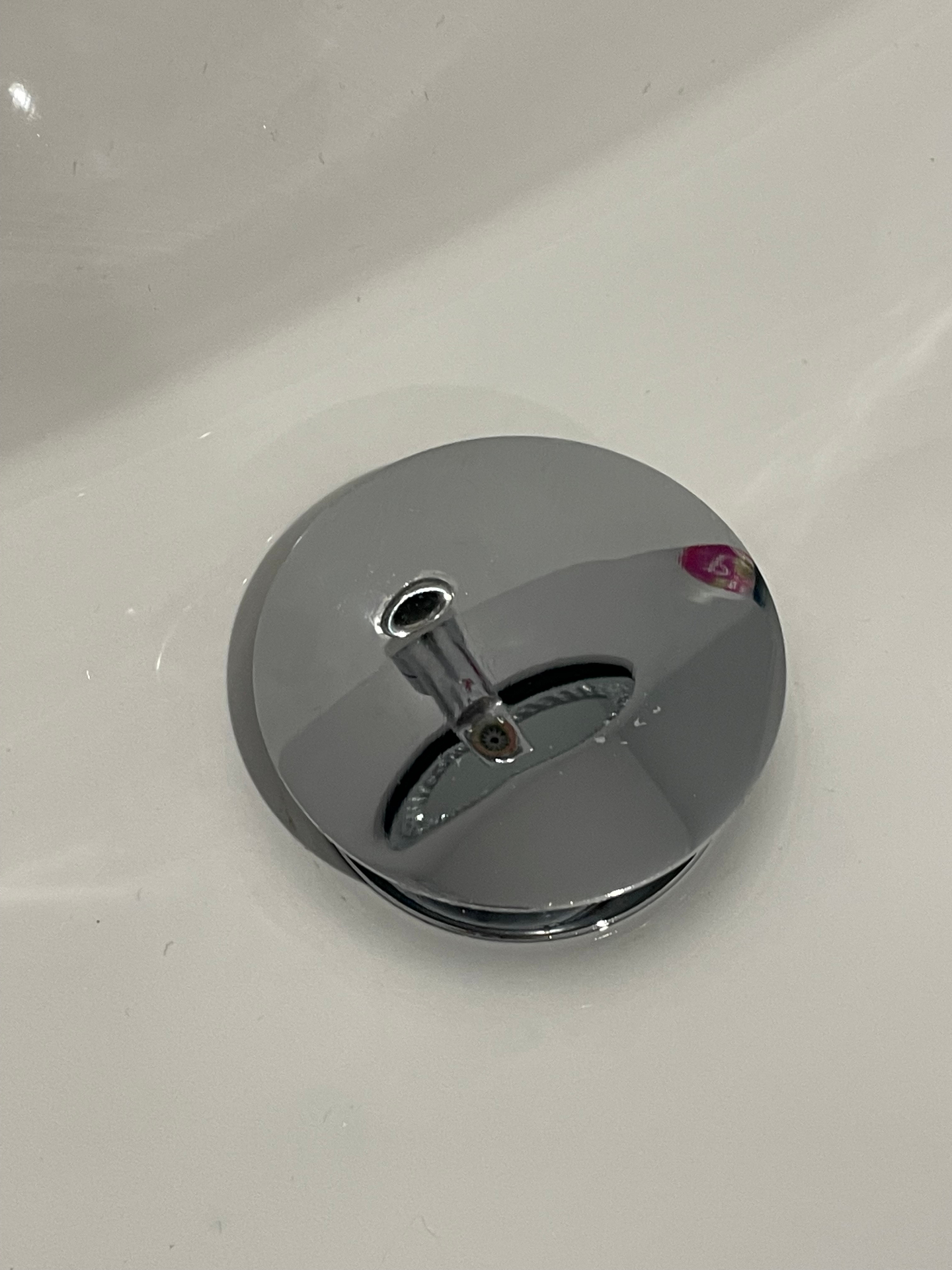 Sink plug after clean — polished chrome finish