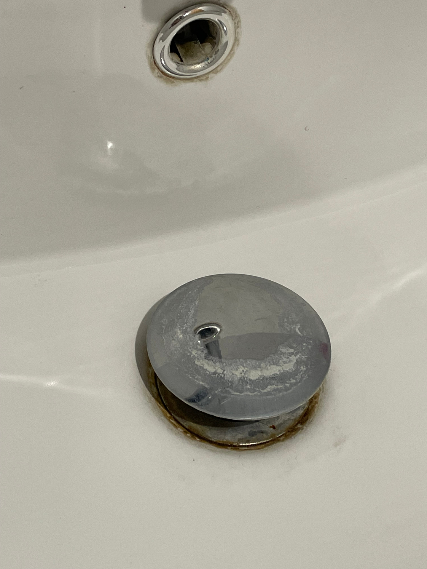 Sink plug before clean — heavy limescale build up