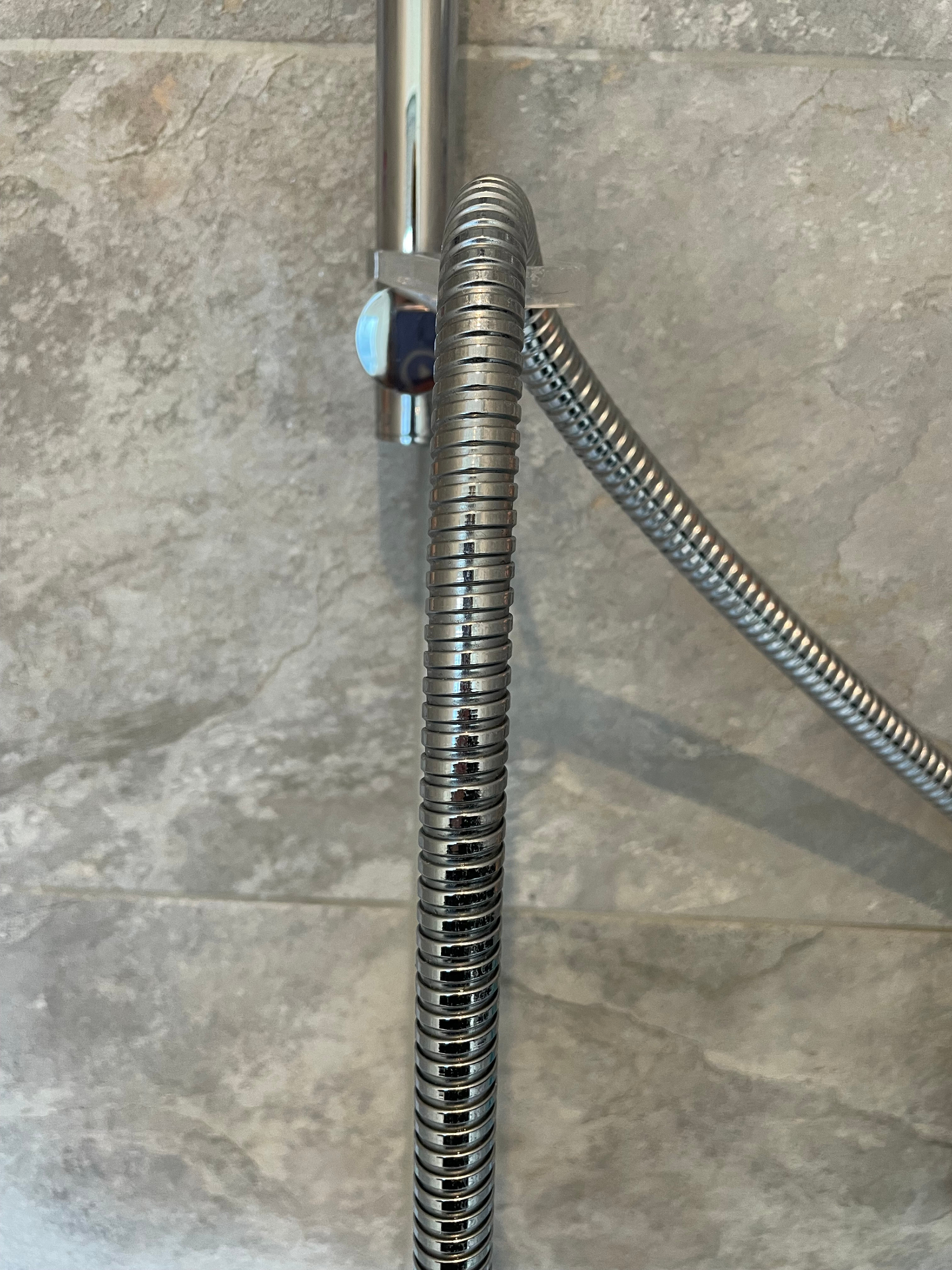 Shower hose after clean — restored chrome shine