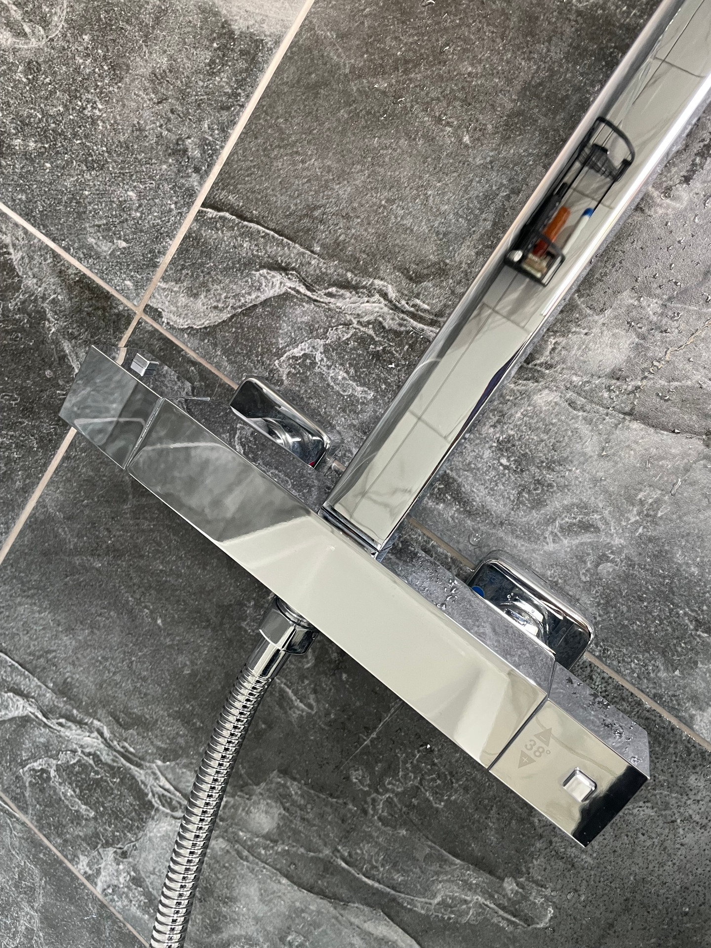 Shower mixer after clean — gleaming chrome finish